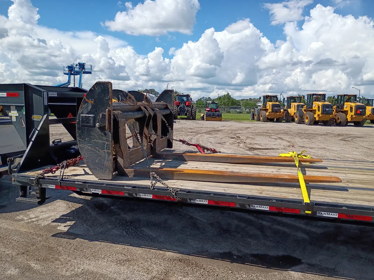 Loader attachments chained at a dealer pickup