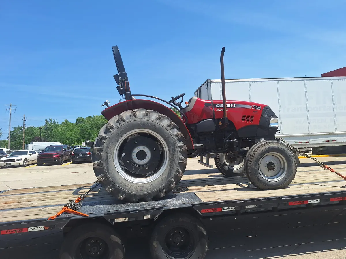 Red Case IH tractor chained down on the trailer