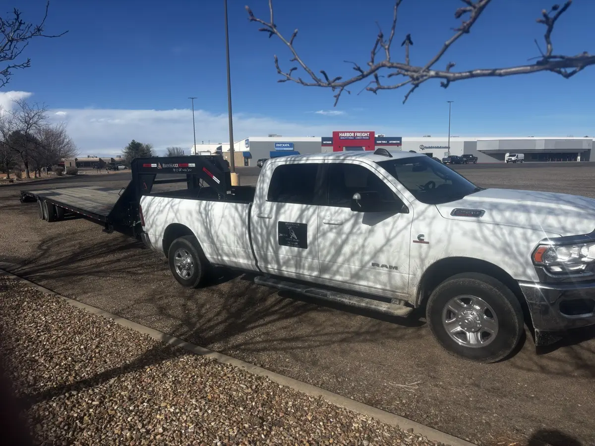 White Raven pickup and empty gooseneck flatbed ready to load